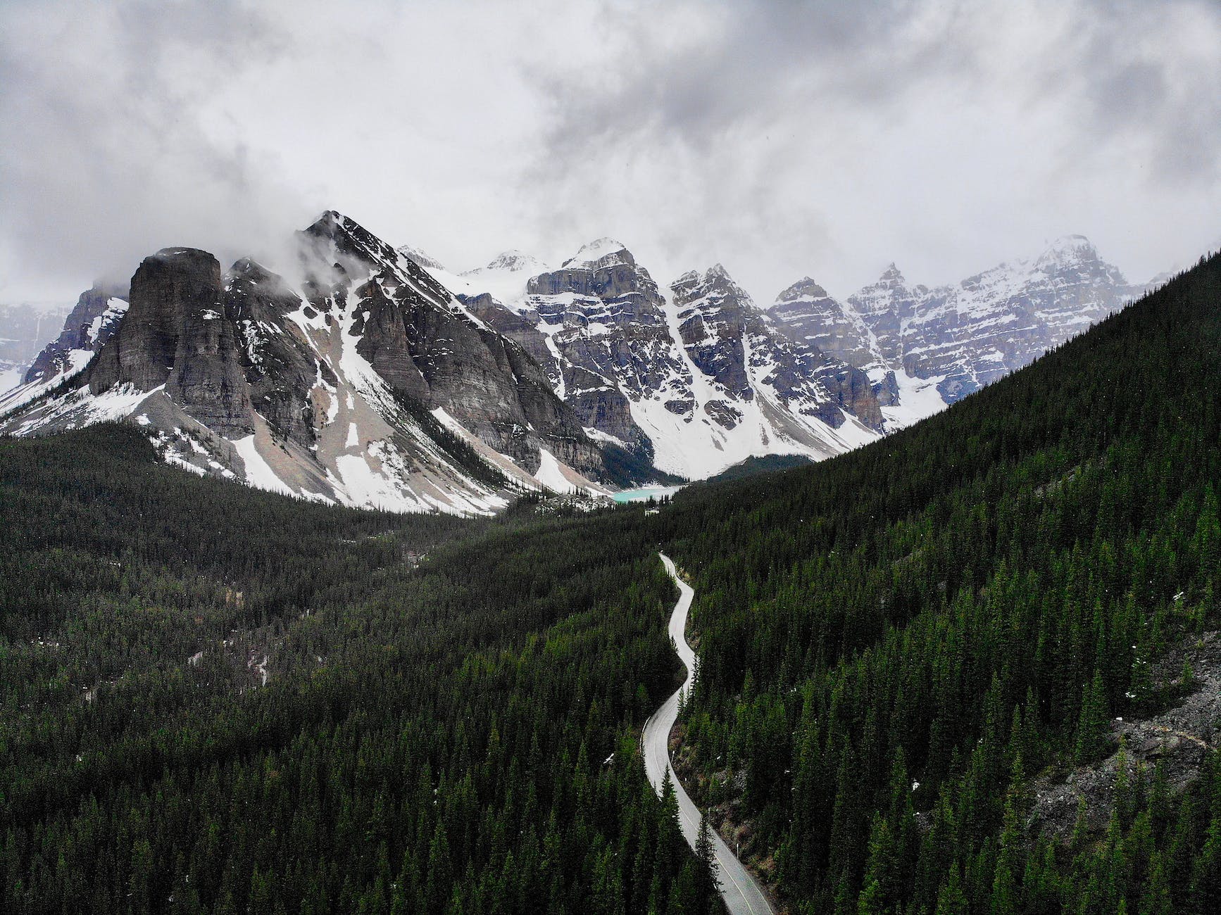 green trees near snow covered mountain travel to Canada